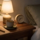 A quiet bedroom at night with a book and water on the bedside table